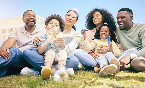 Image of Family, happiness outdoor and relax on lawn, kids blowing bubbles together with grandparents and parents. Happy people, summer and sitting on grass, love and care, bonding with generations and smile