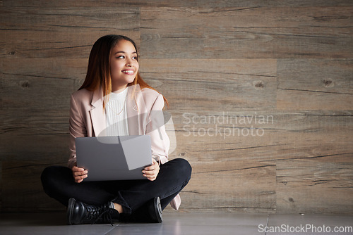 Image of Woman, thinking and laptop with space for idea for advertising or product placement mockup. Smile of female on wooden background for internet connection for search, inspiration or student scholarship