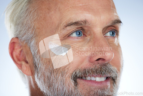 Image of Skincare, cream and face of elderly man in studio for wellness, facial treatment and anti aging cosmetics. Beauty, dermatology and happy male with lotion, hygiene creme and moisturizer for wrinkles