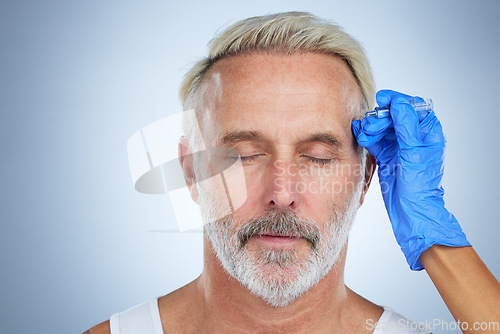 Image of Needle, face and cosmetic of a senior man in a studio doing plastic surgery and cosmetic skincare. Dermatology, wrinkles and anti aging treatment of a mature model with silicone filler injection