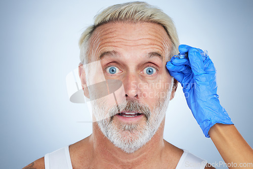 Image of Syringe, portrait and surprise man of a senior face in a studio doing plastic surgery and cosmetic skincare. Dermatology, wrinkles and anti aging treatment of a mature model with filler injection