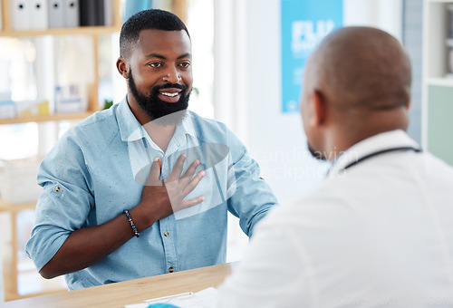 Image of Doctor, patient and consulting in healthcare checkup, illness or appointment at the hospital. Black man talking to medical professional about chest pain, consultation or health problems at clinic