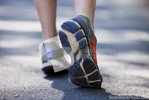 Image of Feet, fitness and person in the road for walking, exercise and training. Active, sports and closeup of the shoes of a runner or athlete in the street to start running, jogging or cardio workout