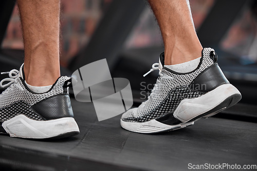 Image of Shoes, man and running on treadmill in gym for exercise, healthy fitness and cardio workout. Closeup athlete, feet and walking machine of sports training, energy and power of action, sneakers or legs