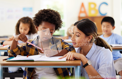 Image of Teacher, learning and helping black kid in classroom for knowledge, studying or assessment. Teaching, development and boy or student with woman for education answer in notebook in kindergarten.