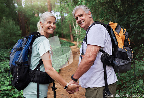 Image of Nature, hiking and portrait of old couple holding hands on adventure in forest, woods and mountain for exercise. Fitness, retirement and happy elderly man and woman smile trekking for travel wellness