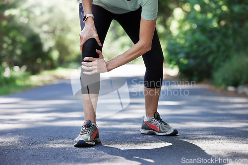 Image of Running, knee pain and old woman with hand on leg in park for outdoor fitness and workout exercise. Health, wellness and muscle strain, senior runner with injury, hands on ache in support or relief.