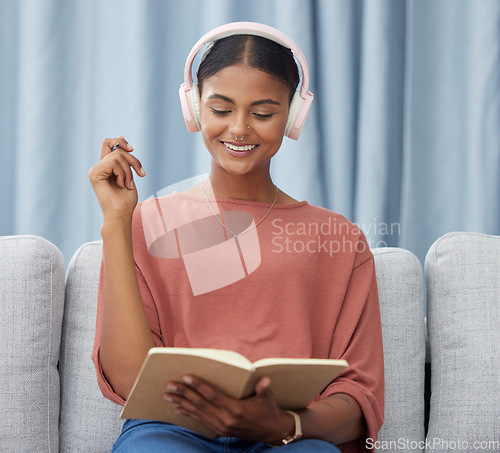 Image of Writing woman, couch and headphones in a living room with a smile from planner notes. Home, journal and creative writer with ideas and on a lounge sofa in house with happiness from notebook planning