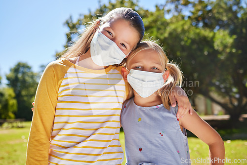 Image of Portrait, mask and friends hug, outdoor while bonding, loving together and relax. Kids, young girl and student children embrace and cover faces outside at park or garden in covid pandemic at school