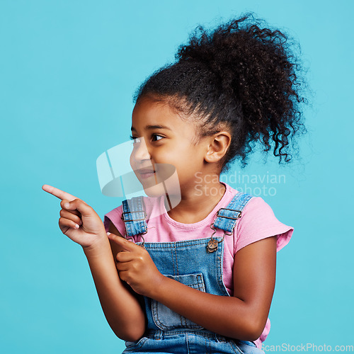 Image of Studio, youth girl and kid point at commercial promotion, advertising copy space or marketing mockup. Child growth mock up, brand product placement and young female face isolated on blue background