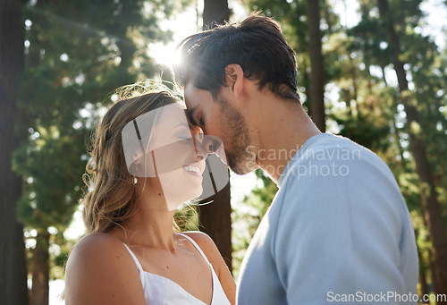 Image of Couple forehead touch, content in nature and happy, travel and relax together, smile outdoor with love and care. Summer, holiday with man and woman, sunshine and relationship with trust and peace