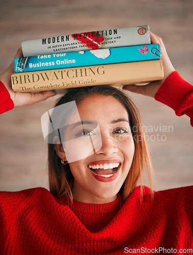 Image of Reading, portrait and student with books on her head while studying in college for a test or exam. Happy, smile and excited young woman with stories, novels or fiction standing by wall in the library