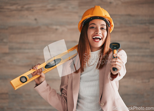 Image of Engineer, business woman laugh and portrait of a property architect with construction tools. Safety helmet, stud detector and engineering gear for a home renovation project with female employee