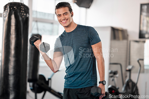 Image of Portrait, dumbbells and man in gym smile with earphones for streaming music while exercising. Sports workout, fitness and happy bodybuilder or athlete lifting weights for exercise, health and muscle.