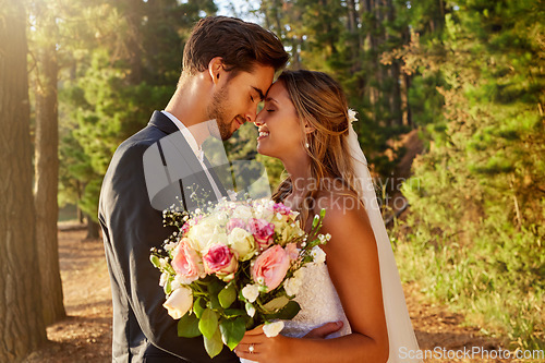 Image of Wedding, kiss and love with couple in nature for celebration, marriage and ceremony. Happiness, affectionate and romance with man and woman in forest with bouquet for elegant, relationship and hug