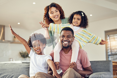 Image of Happy family, piggyback and portrait of kids with parents on a sofa, smile and cheerful while bonding in their home. Airplane, fun and face of children with mother and father in living room together