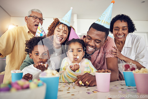 Image of Birthday party, blow and confetti with family in kitchen for celebration, bonding and affectionate. Happy, excited and grandparents with parents and children at home for surprise, fun or event