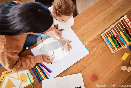 Image of Learning, top view and mother with kid drawing in book in family home for studying, homework or homeschool help. Creative development, art and boy with mom teaching him art for education child growth