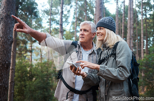 Image of Senior couple, hiking and phone outdoor in nature for direction for exercise, fitness and trekking. Old man and woman with smartphone and hand on forest hike for workout, cardio and gps or compass