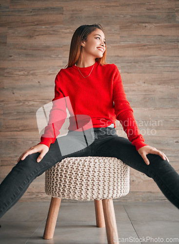 Image of Happy, relax and a woman thinking on a chair with fashion, idea and vision in a living room. Smile, lifestyle and a girl sitting with stylish clothing, confidence and happiness in a home lounge