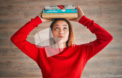 Image of Reading, student and woman with books on her head while studying in college for a test or exam. Thinking, thoughtful and young female with stories, novels or fiction standing by a wall in the library