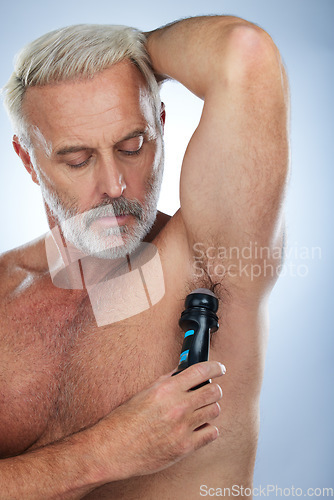 Image of Skincare, deodorant and senior man for armpit, body hygiene and beauty products on blue background. Wellness, grooming mockup and elderly male with antiperspirant, fragrance and underarm in studio