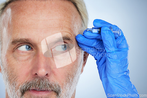 Image of Senior, face closeup and needle of a man in a studio doing plastic surgery and cosmetic skincare. Dermatology, wrinkles and anti aging treatment of a mature model with silicone filler injection