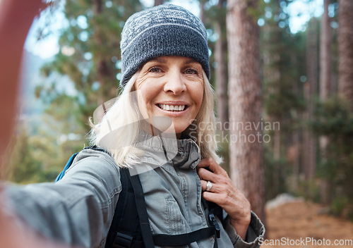 Image of Selfie, hiking and a senior woman in the forest for fitness, adventure or the exploration of nature. Portrait, travel and exercise with a mature female hiker in the mountains or woods for a hike