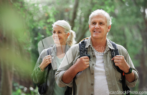 Image of Hiking, elderly couple and active seniors in a forest, happy and relax while walking in nature. Senior, backpacker and woman with man outdoors for travel, freedom and healthy lifestyle in retirement