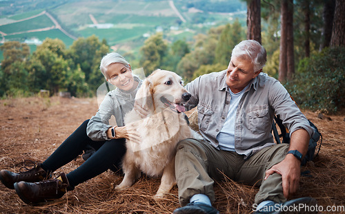 Image of Dog petting, hiking and a couple in nature for travel, relaxation and break on a mountain. Happy, relax and an elderly man and woman with an animal on a walk in the mountains and resting together