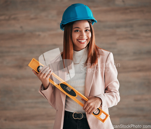 Image of Architect, woman and portrait smile with level tool for measuring balance in construction planning. Happy female contractor, engineer or builder smiling with safety helmet equipment for architecture