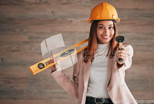 Image of Architect, business woman and portrait of a property management worker with construction tools. Safety helmet, smile and stud detector for a home renovation project with a happy female employee