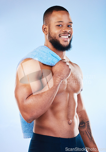 Image of Black man, portrait and body towel with a smile in studio for health, wellness and fitness. Face of healthy male aesthetic model with clean skin, strong muscle and happiness on a blue background