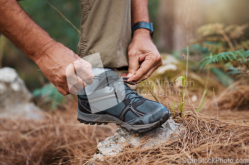 Image of Closeup, hands and tie shoes on hike, start walk and fitness for wellness, workout and exercise. Male, hiker and guy tying shoelace, prepare for hiking and training for cardio and healthy lifestyle
