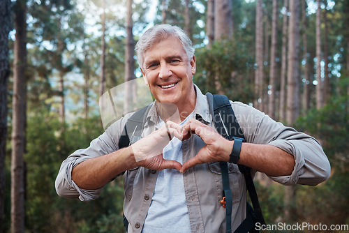 Image of Portrait, heart and senior man in forest hiking, fitness and health support, self care hands and cardiovascular workout. Nature, travel or trekking of happy person in woods with love sign or emoji