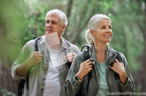 Image of Elderly couple, hiking and active seniors in a forest, happy and relax while walking in nature. Senior, backpacker and woman with man outdoors for travel, freedom and healthy lifestyle in retirement