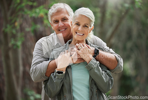 Image of Hug, hiking and portrait of senior couple with smile on adventure in forest, woods and mountain for exercise. Fitness, retirement and happy elderly man and woman trekking, walk and hike for wellness