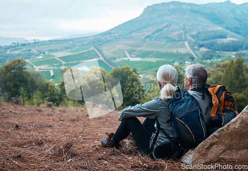 Image of Retirement, hiking and old couple with relax with view of hill from back in Peru on holiday adventure. Travel, senior man and woman resting on cliff, hike or trekking with love, health and backpack.