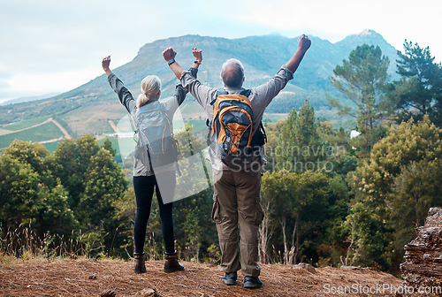 Image of Hiking, mature couple and arms raised on cliff from back on nature walk and mountain in view in Peru. Travel, senior man and woman celebrate forest hike with love and achievement on holiday adventure