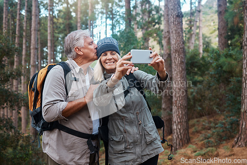 Image of Elderly, couple take selfie and hiking in forest, happy people in nature and memory for social media post. Smile in picture, adventure and fitness, old man and woman are outdoor with active lifestyle