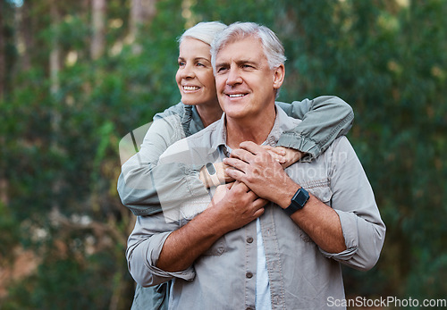 Image of Senior couple, hiking and hug outdoor in nature for exercise, fitness and trekking for health and wellness. Old man and woman thinking, care and smile on forest hike for cardio workout in retirement