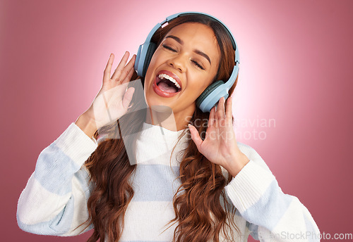 Image of Mockup, sing and woman with headphones, streaming music and happiness against pink studio background. Female, happy lady and headset for sounds, listening to radio or audio for wellness or motivation