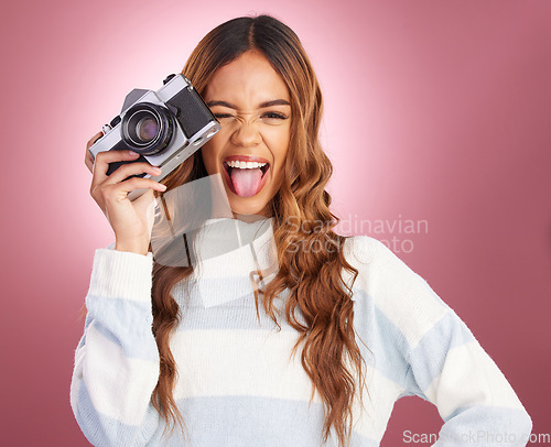 Image of Photographer, camera and face of woman with tongue out in studio for fun, gen z and retro aesthetic on pink background. Lens, photography and portrait of girl with picture, emoji and isolated mockup