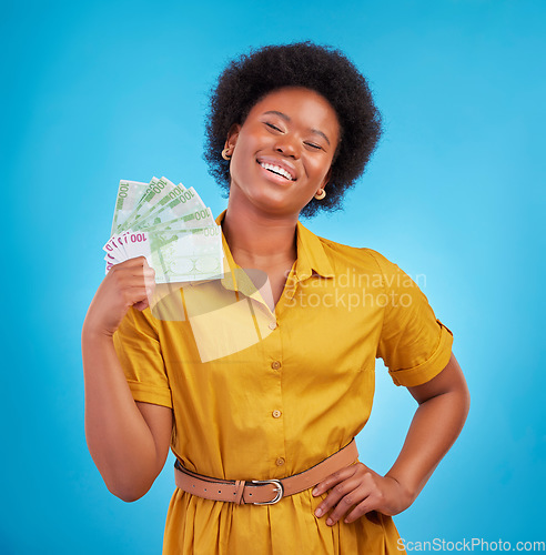 Image of Black woman, money fan and smile in studio for winning, finance goal and success by blue background. Girl, happiness and cash in hand from casino, gambling and winner with wealth, rich and proud