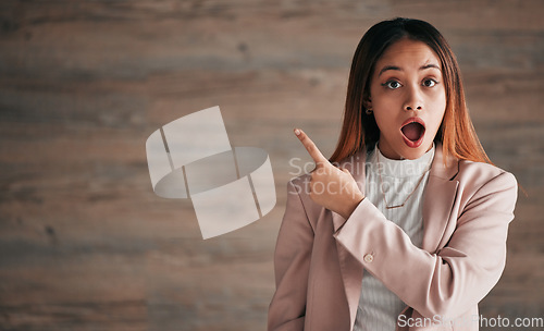 Image of Shocked woman, portrait and pointing on mockup for announcement, advertising or marketing. Surprised business female point finger to copy space in shock for advertisement against a studio background