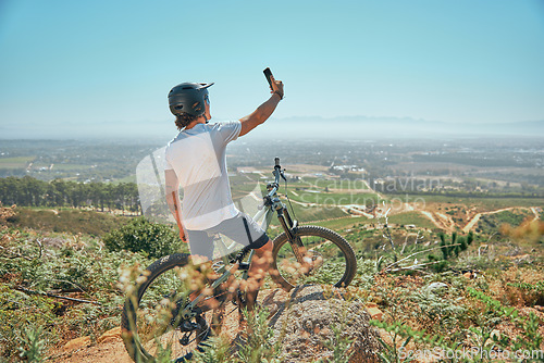 Image of Fitness, selfie and man on a bicycle with phone for cycling, photography or photo in nature. Cyclist, workout and social media health influencer live streaming for blog, website or profile picture