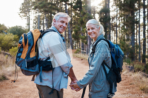 Image of Love, hiking and portrait of old couple holding hands on nature walk in mountain forest in Canada. Travel, senior man and woman on hike with smile on face and health on retirement holiday adventure.