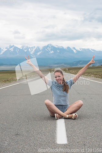 Image of Woman sitting on the road