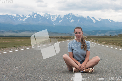 Image of Woman sitting on the road