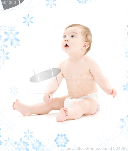 Image of baby boy in diaper with toothbrush